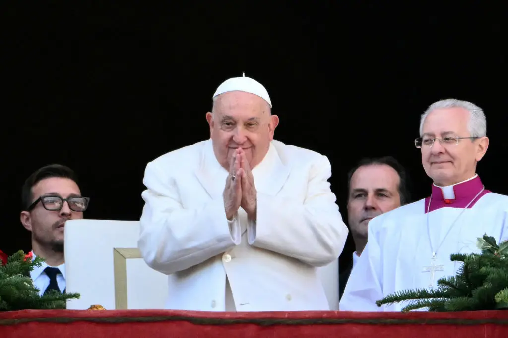 Pope Francis greeting a crowd from the Vatican balcony (ALBERTO PIZZOLI/AFP via Getty Images)
