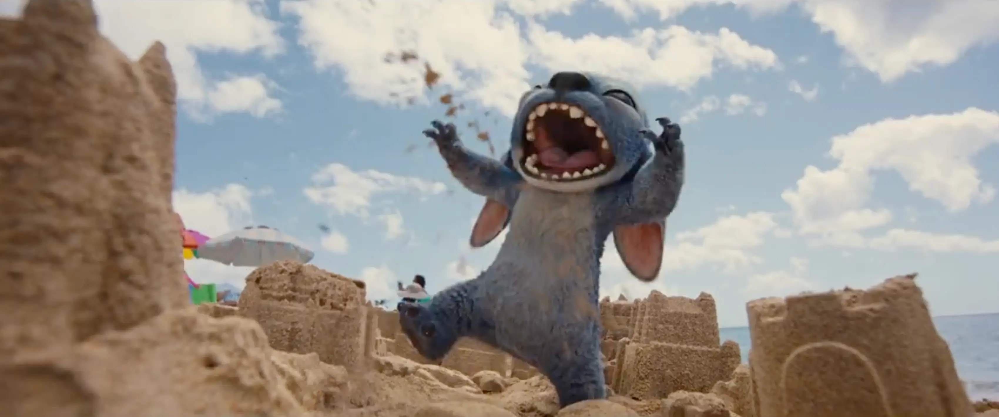 Stitch comically terrorizes a sand castle in the teaser (Disney)