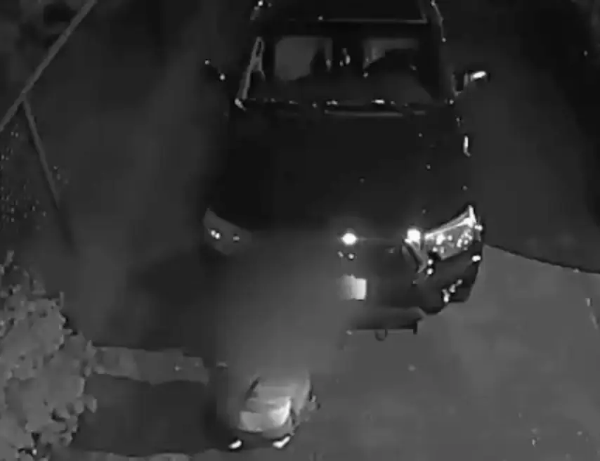 The woman hid behind a car to escape. (KATU News)