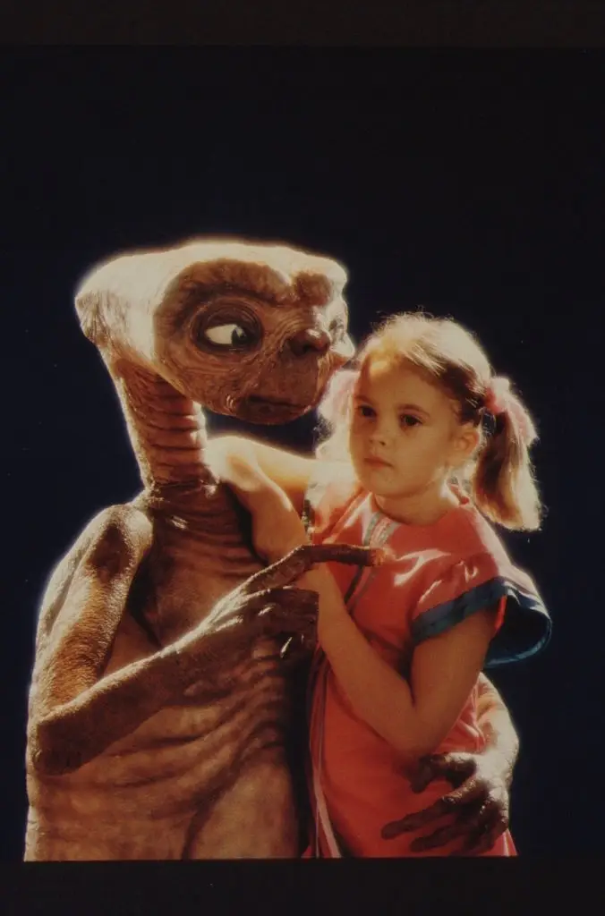Drew Barrymore poses with E.T. at Carlo Rimbaldi studio in April, 1982 in Los Angeles, California. (Photo by Mark Sennet/Getty Images)