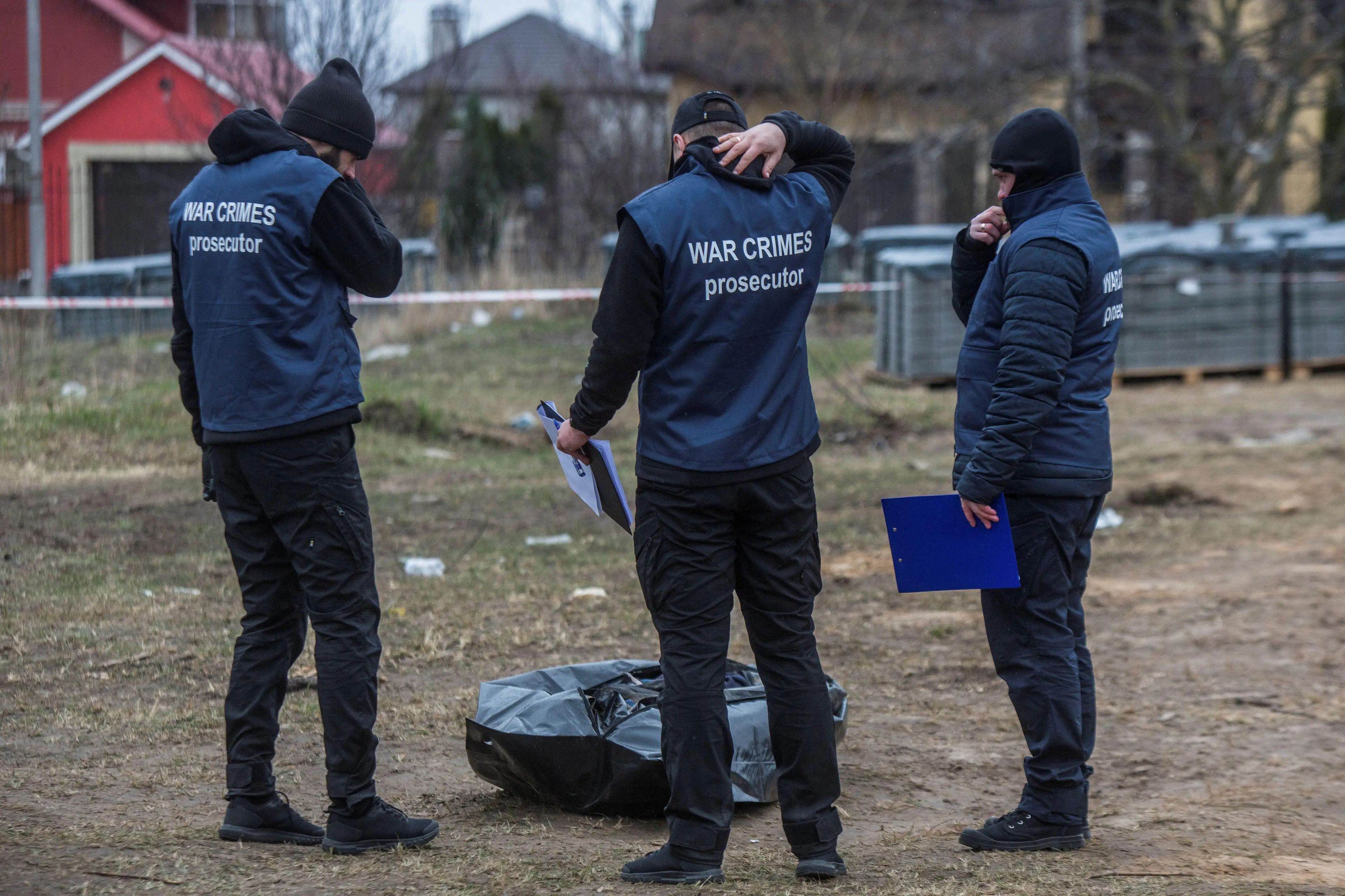 War crimes prosecutors attend the Bucha massacre.