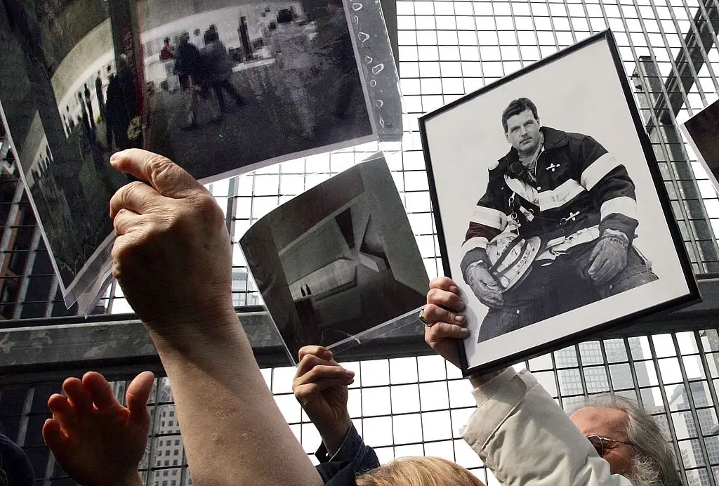 A photo of deceased firefighter Orio Palmer being held by his sister (Mario Tama/Getty Images)