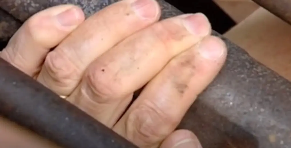 When Parker reached for an iron bar to jam into a chain-and-sprocket that drove the rollers, he started to cut his own fingers off to free himself.