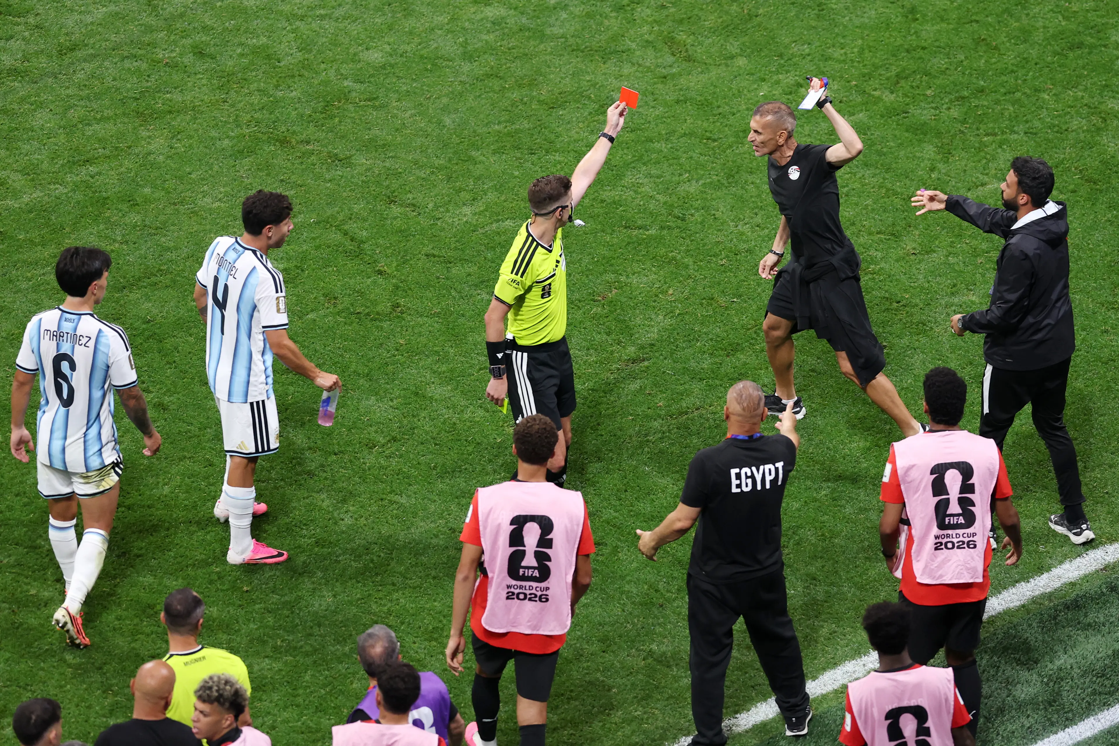 In chaotic scenes players and officials swarmed the pitch to argue with the referee ( Michael Regan - FIFA/FIFA via Getty Images)