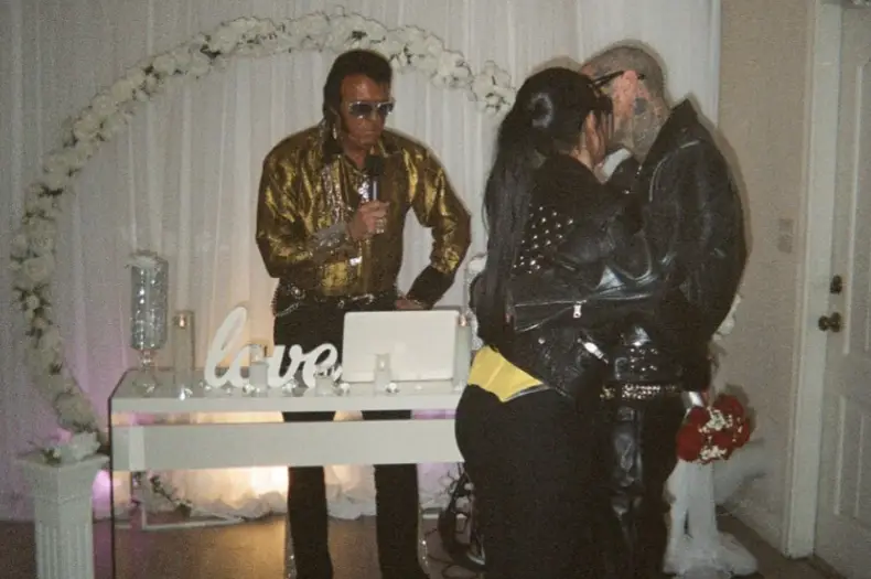 Kourtney and Travis in front of Elvis.