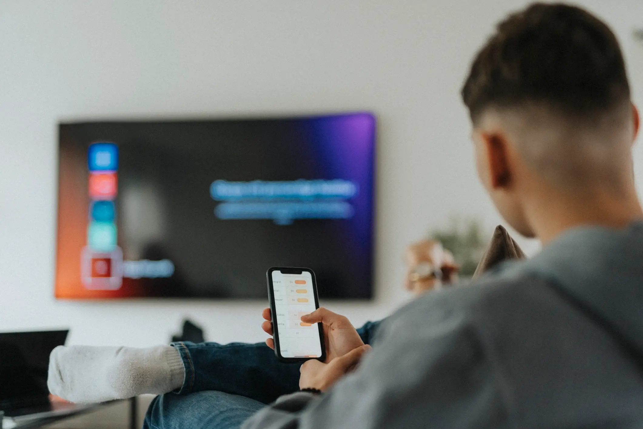 Many Gen Z's scroll on their phones while watching TV (Getty Stock)