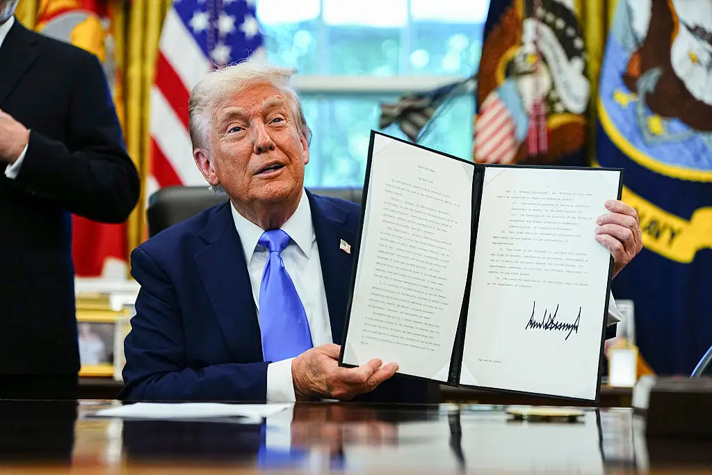 President Donald Trump signs a proclamation that would move to extensively overhaul the H-1B visa program (Aaron Schwartz/CNP/Bloomberg via Getty Images)