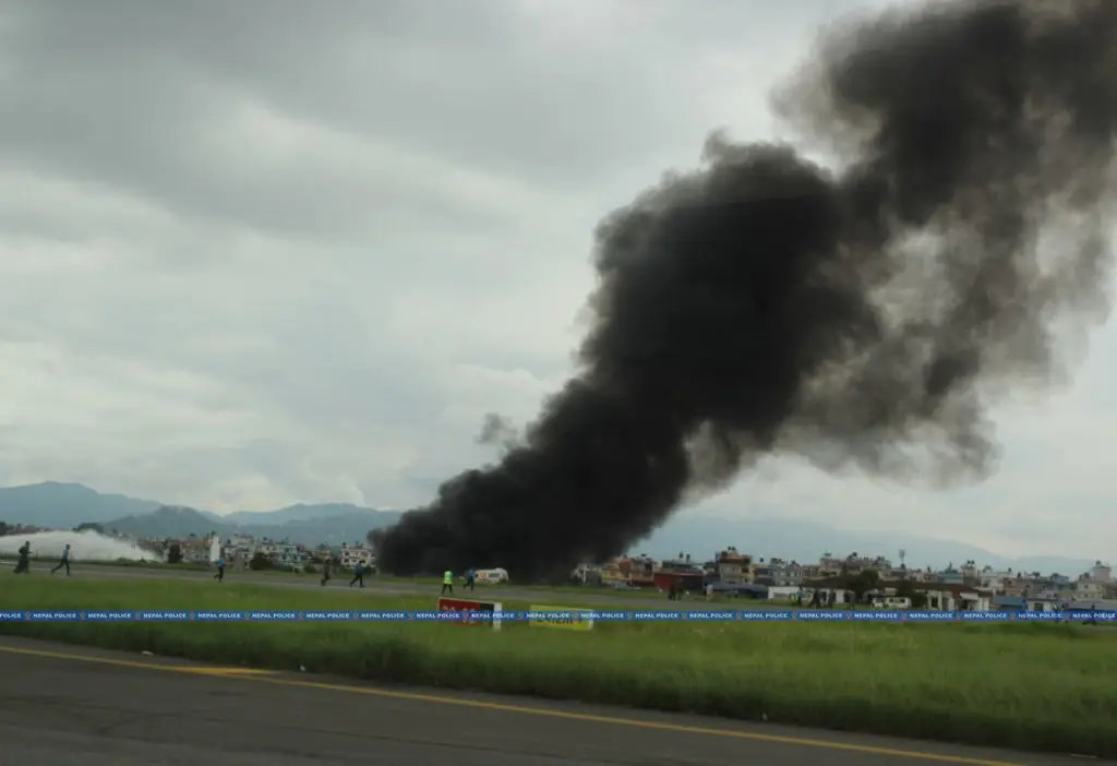 A plume of black smoke billowed from the wreckage. (Nepal Police/Anadolu via Getty Images)