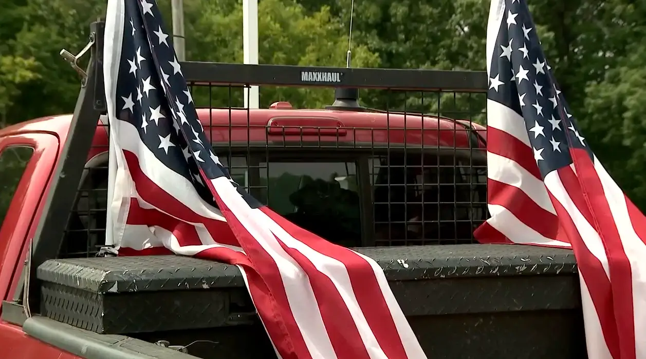 Hartless' stepmother has stood by his decision to keep the flags on his truck.