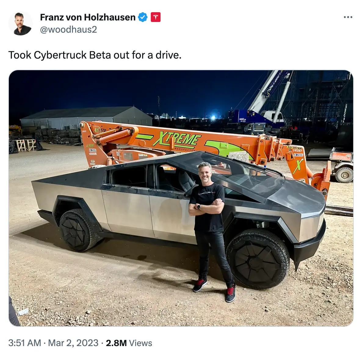 Tesla's design chief Franz von Holzhause posing with a rather dusty looking Cybertruck.