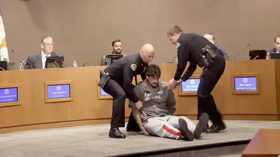 Ex-NFL player arrested after calling MAGA 'a Nazi movement' in heated protest at library