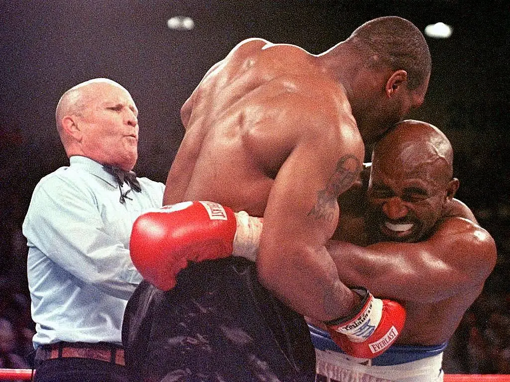 Referee Lane Mills steps in as Evander Holyfield reacts after Mike Tyson bit his ear in the third round of their WBA heavyweight championship fight at the MGM Grand Garden Arena in Las Vegas, 1997 (JEFF HAYNES/AFP via Getty Images)
