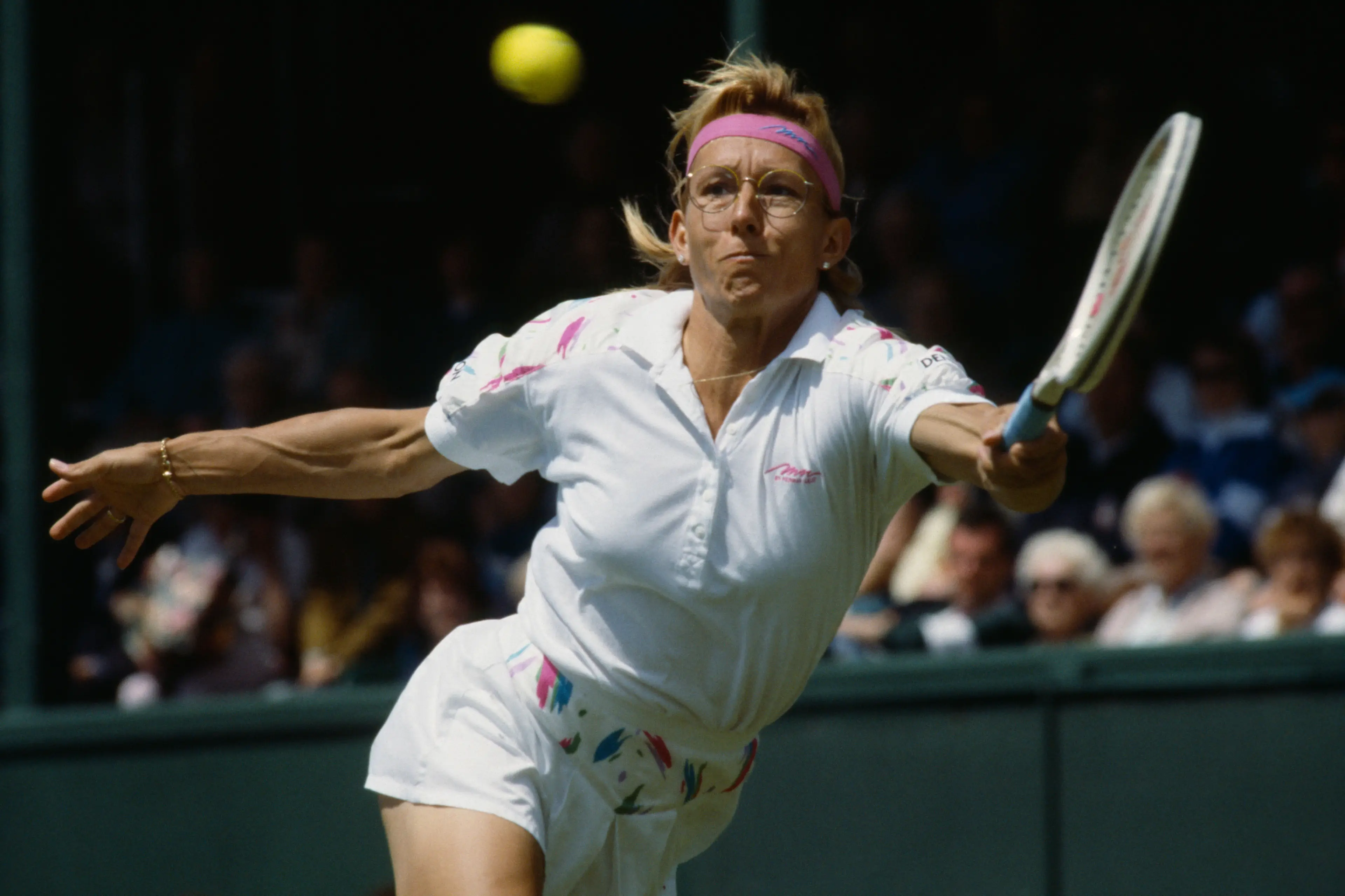 Martina Navratilova stretching for return during match at Wimbledon.