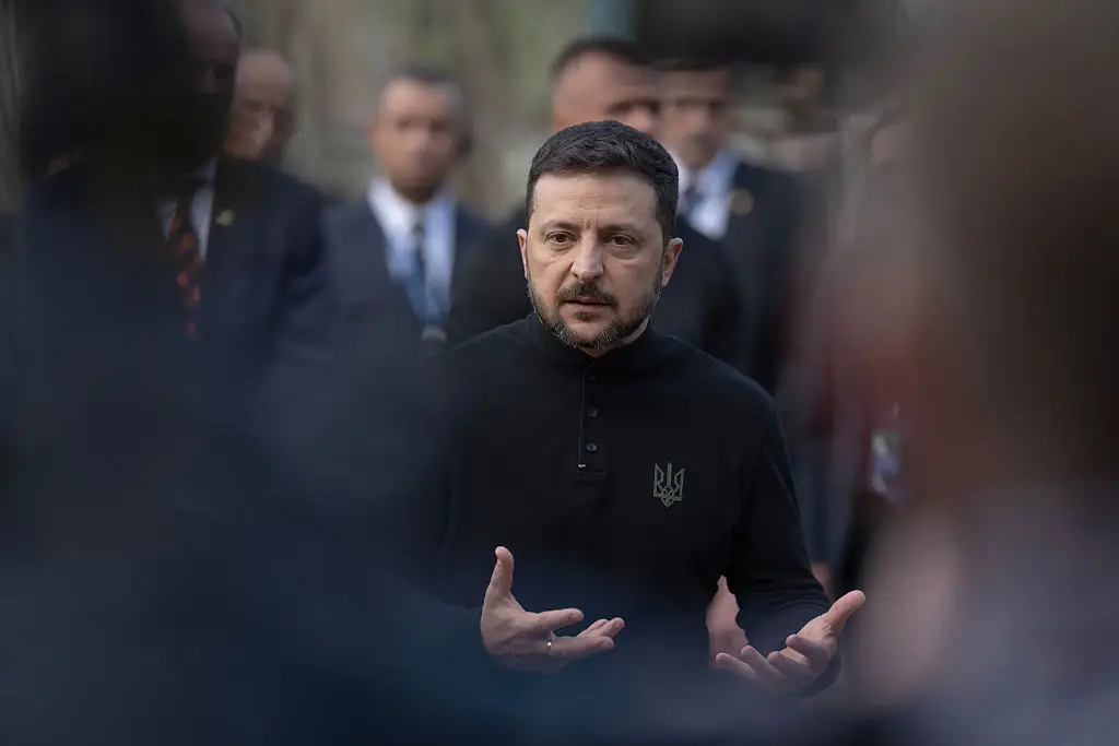 Ukrainian President Volodymyr Zelenskyy speaks to members of the media as he visits the site of a Russian strike in Kyiv, Ukraine, last month (Andrew Kravchenko/Bloomberg via Getty Images)