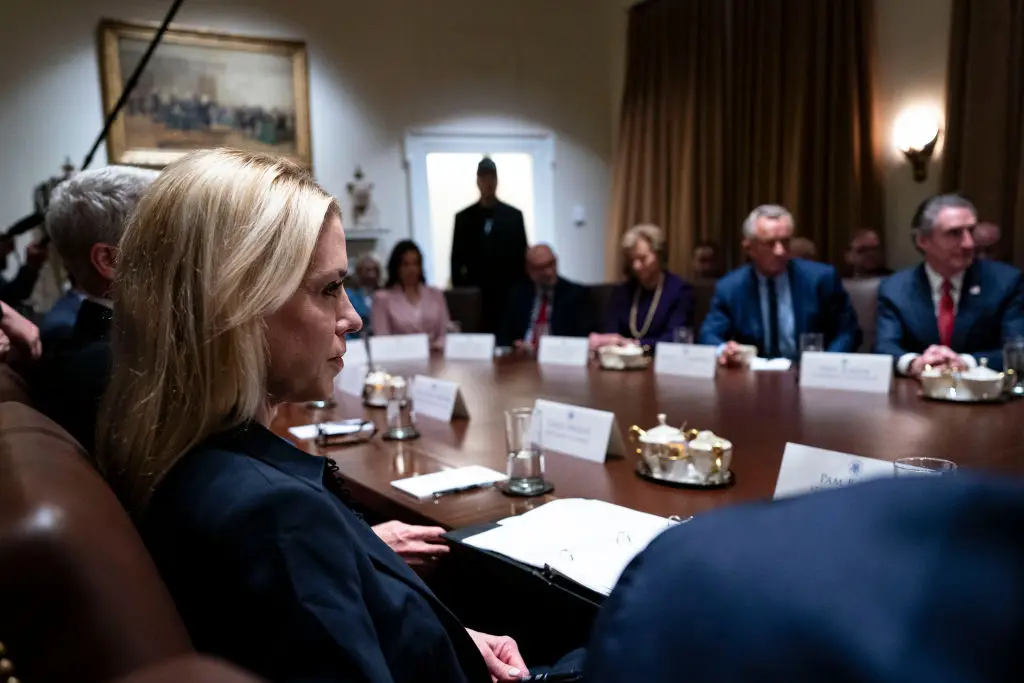 US Attorney General Pam Bondi at President Donald Trump's first Cabinet Meeting of his second-term, with Elon Musk standing in the background (Al Drago/Bloomberg via Getty Images
