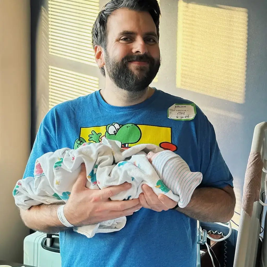 David Allen smiles with his newborn baby Lily Grace Allen following her birth in June. (Instagram/@totouchanemu)