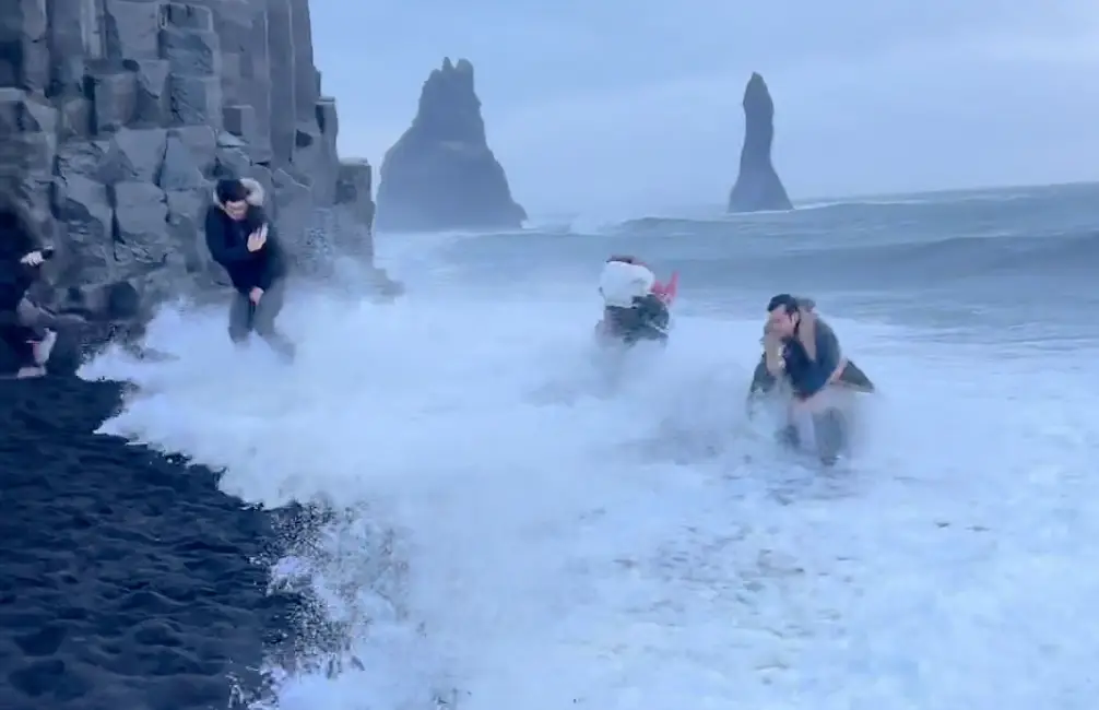 The strong waves cause two of them to drop while the rest flee inland.