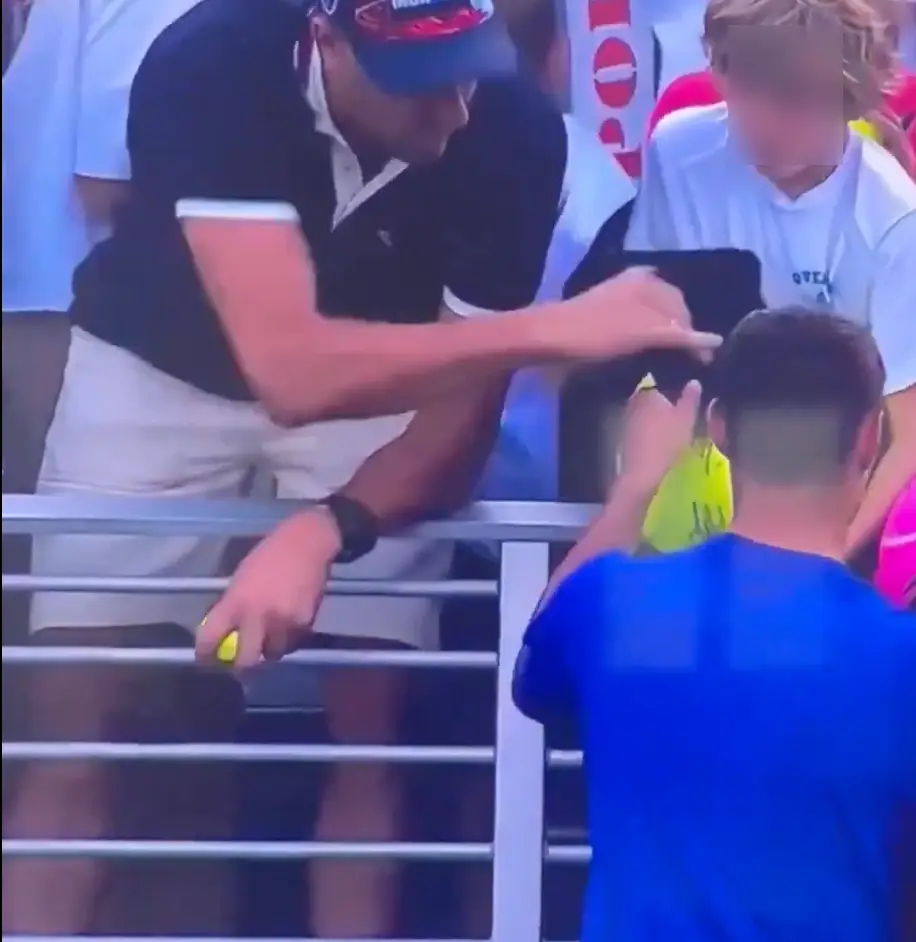 The millionaire CEO seemingly wasted no time in swiping the hat from the kid (USTA)