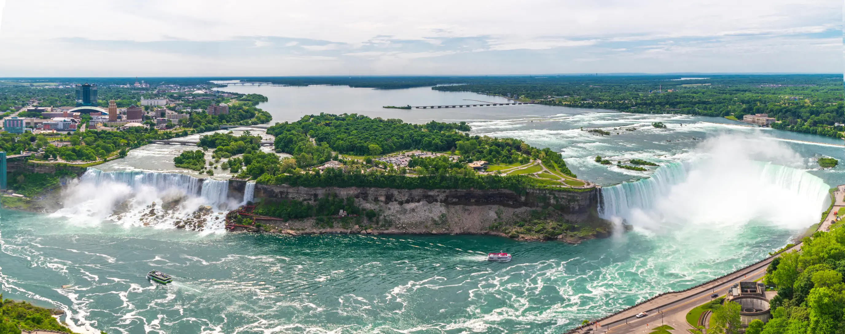 Luna Island is pictured at the right of falls on the left hand side, and has a rocky terrain at the bottom (Getty stock)