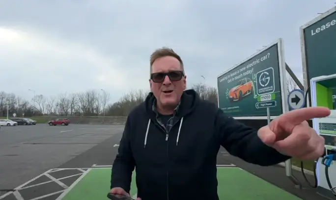 Lee attempting to charge the EV (YouTube/TheMacMaster)