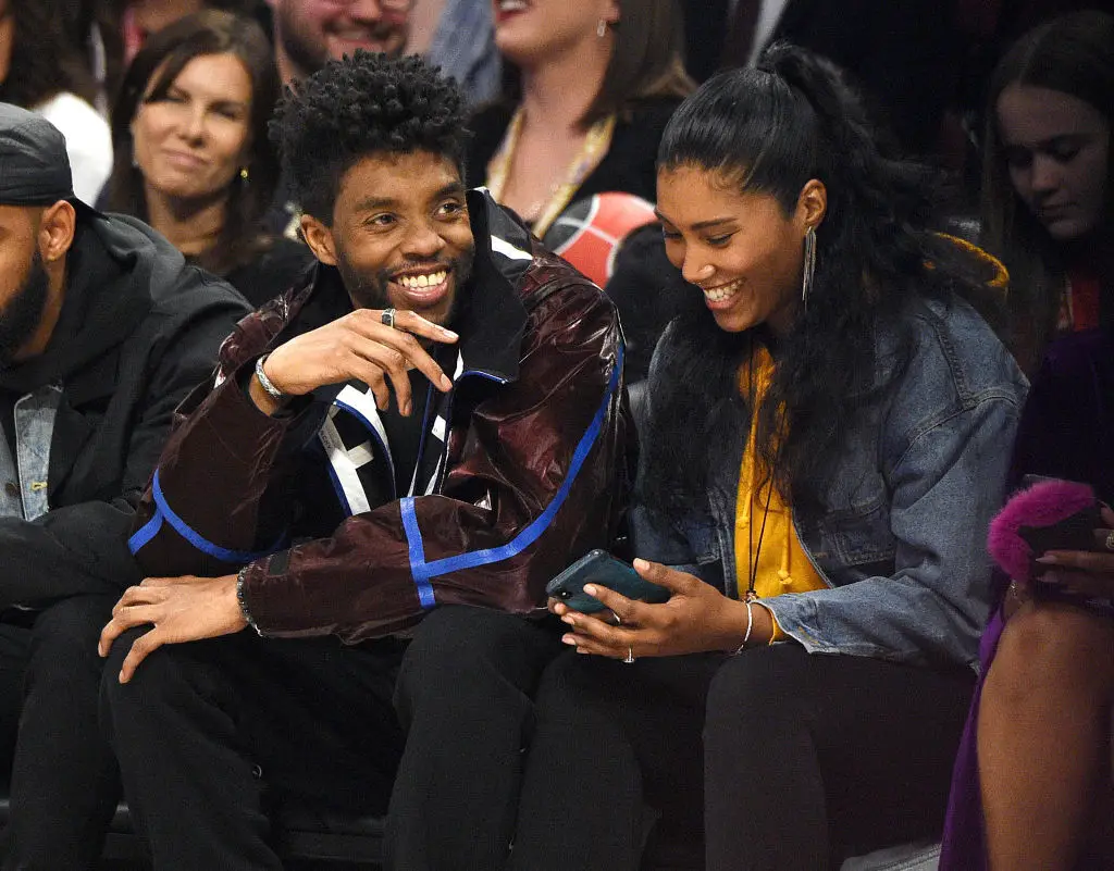 The late Chadwick Boseman pictured with his wife watching basketball (Kevin Mazur/Contributor/Getty)