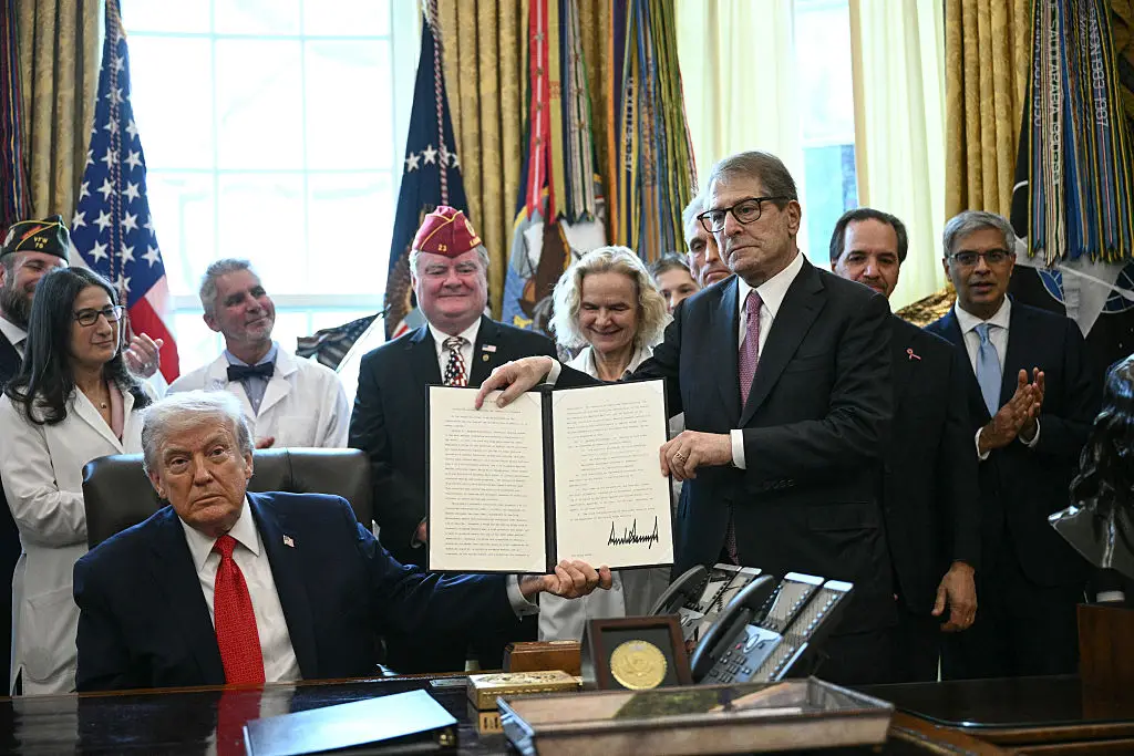 Trump holding the order reclassifying marijuana (Brendan SMIALOWSKI / AFP via Getty Images)