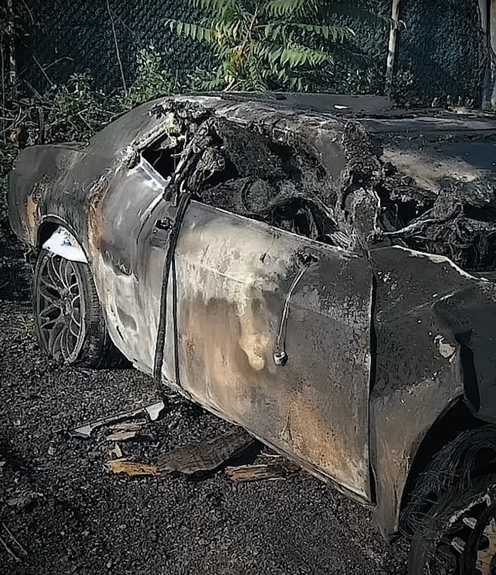 The teen's burned Dodge Challenger pictured shortly after the accident took place (Joe DiMeo)