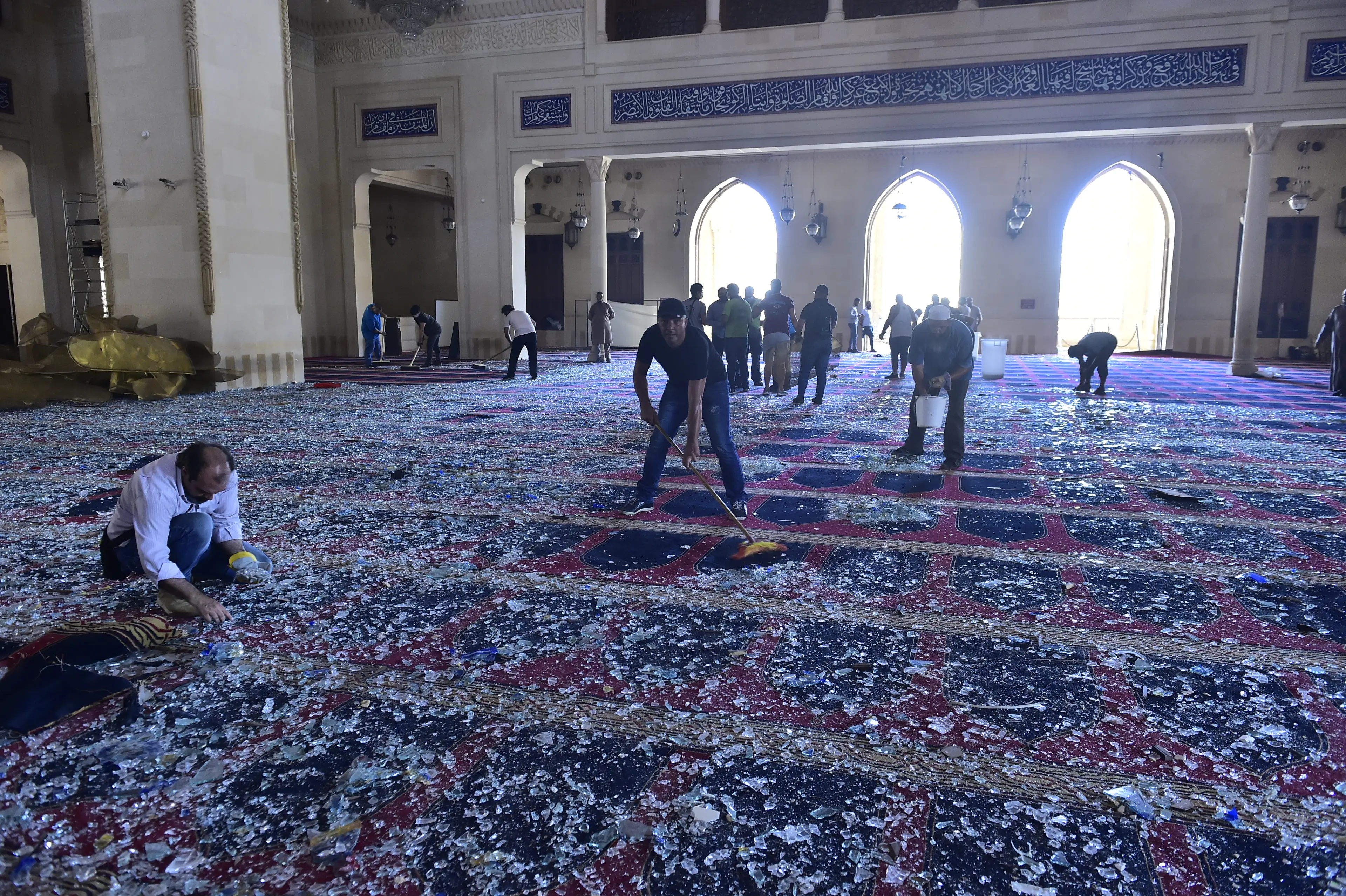 Volunteers sweep up broken glass inside the Mohammad Al-Amin Mosque in Beirut. (Houssam Shbaro/Anadolu Agency via Getty Images)