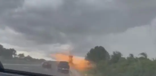 A woman captured her husband's car being struck by lightning.