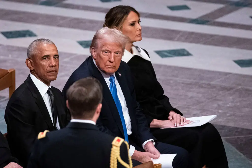 Former President Barack Obama has been accused by President Donald Trump, who he's pictured beside at former President Jimmy Carter's funeral in January, of committing treason (Al Drago/Bloomberg via Getty Images)