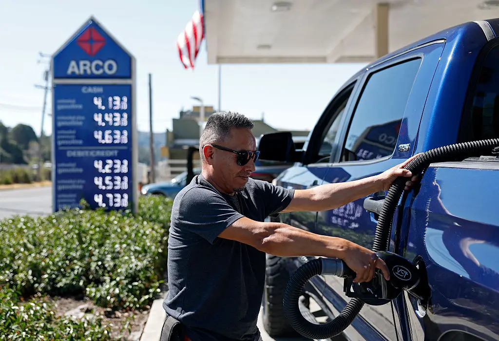 Victor Sanchez pumps gas into his truck at an Arco gas station in Mill Valley, California, as Labor Day gas prices were forecasted to be the lowest since 2020... but I'm sorry to say Victor, you'd actually save a fortune switching to EV! (Justin Sullivan/Getty Images)