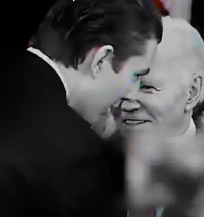 Barron Trump appeared to lean in to speak to Joe Biden in the clip (X/@DefiantLs)