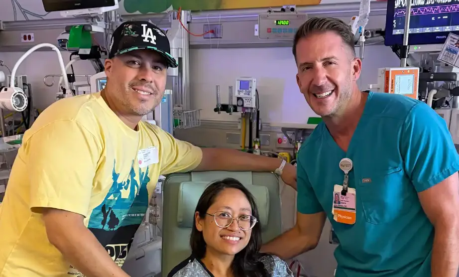 Suze Lopez pictured with her husband Andrew (left) and Dr. John Ozimek after the birth of her miracle baby (Cedars-Sinai)