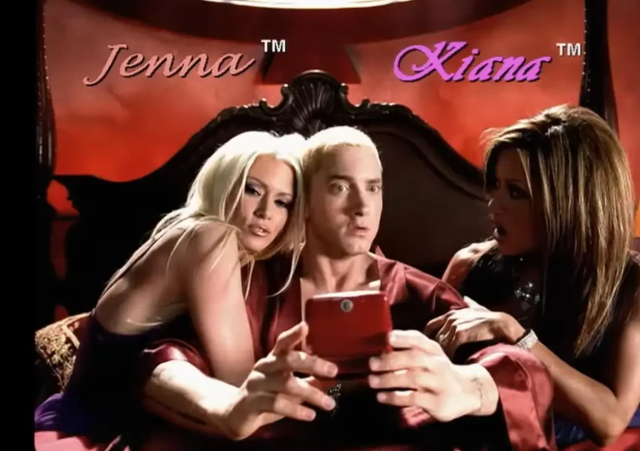 Eminem opened the video in bed with two women. (Eminem/YouTube) 