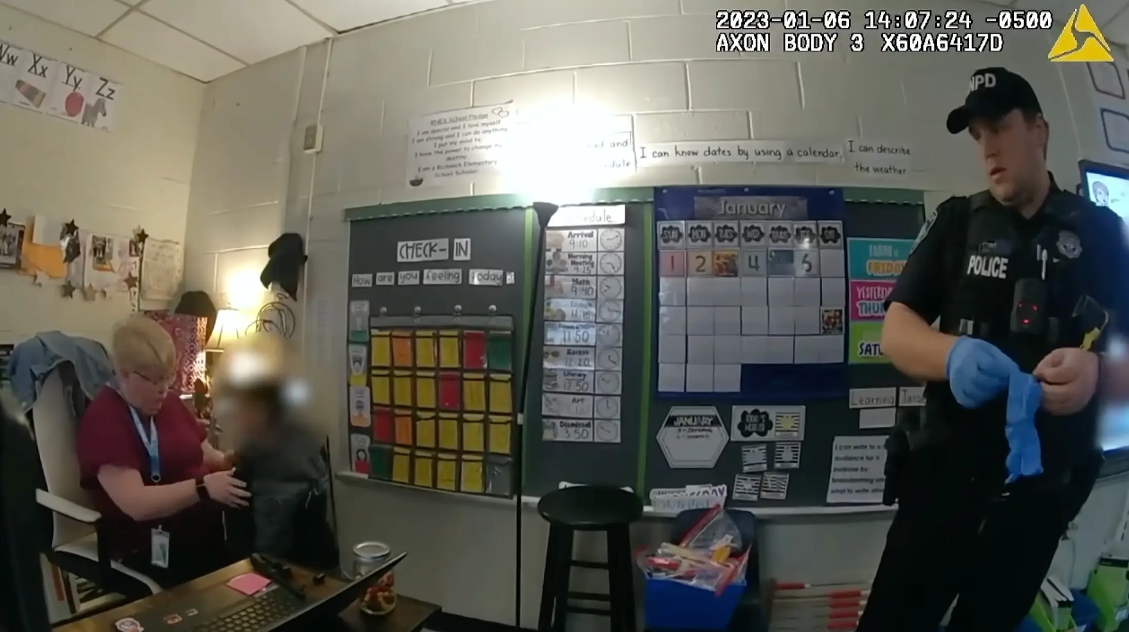 Bodycam footage from the 2023 incident shows the six-year-old being held by another teacher as officers intervene (Newport News Police Department)