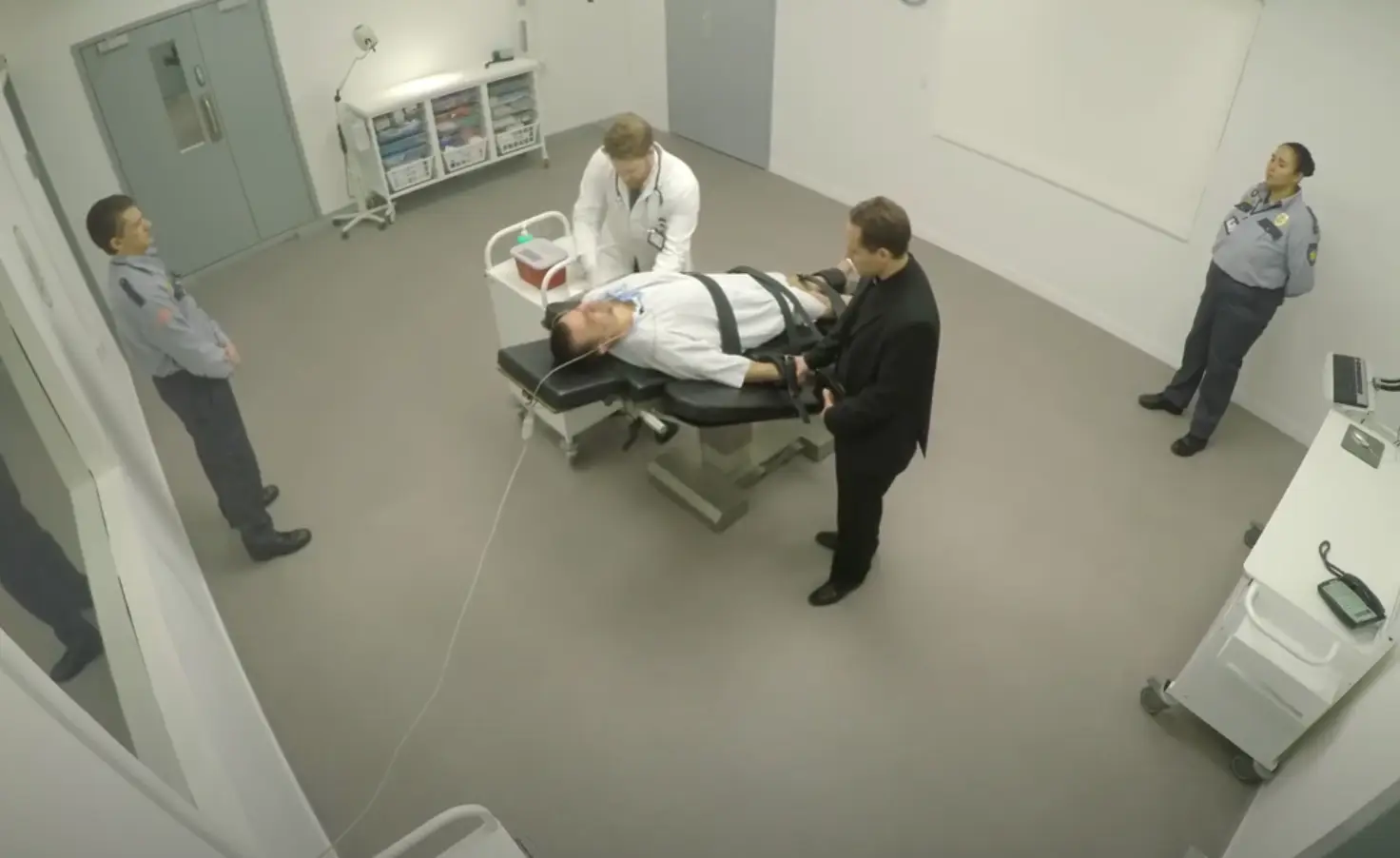 The prisoner has two IV drips inserted.