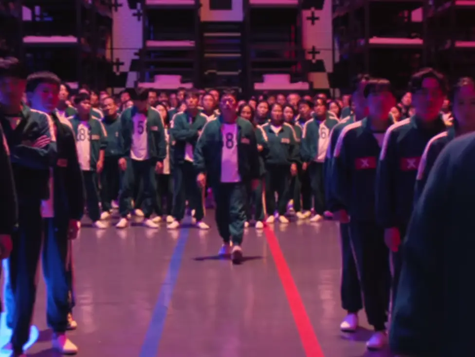 Player 388 walking up to vote, who becomes a young muscular man in the next episode (Netflix)