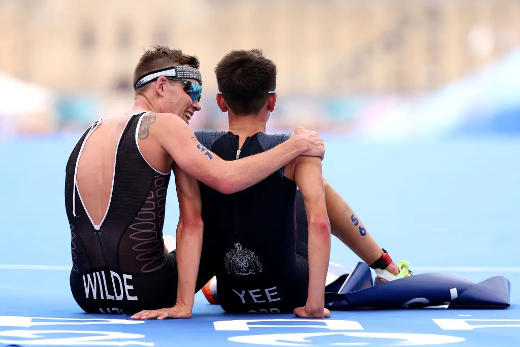 The two athletes taking a moment of well-earned rest after the race ended. (Ezra Shaw/Getty Images)