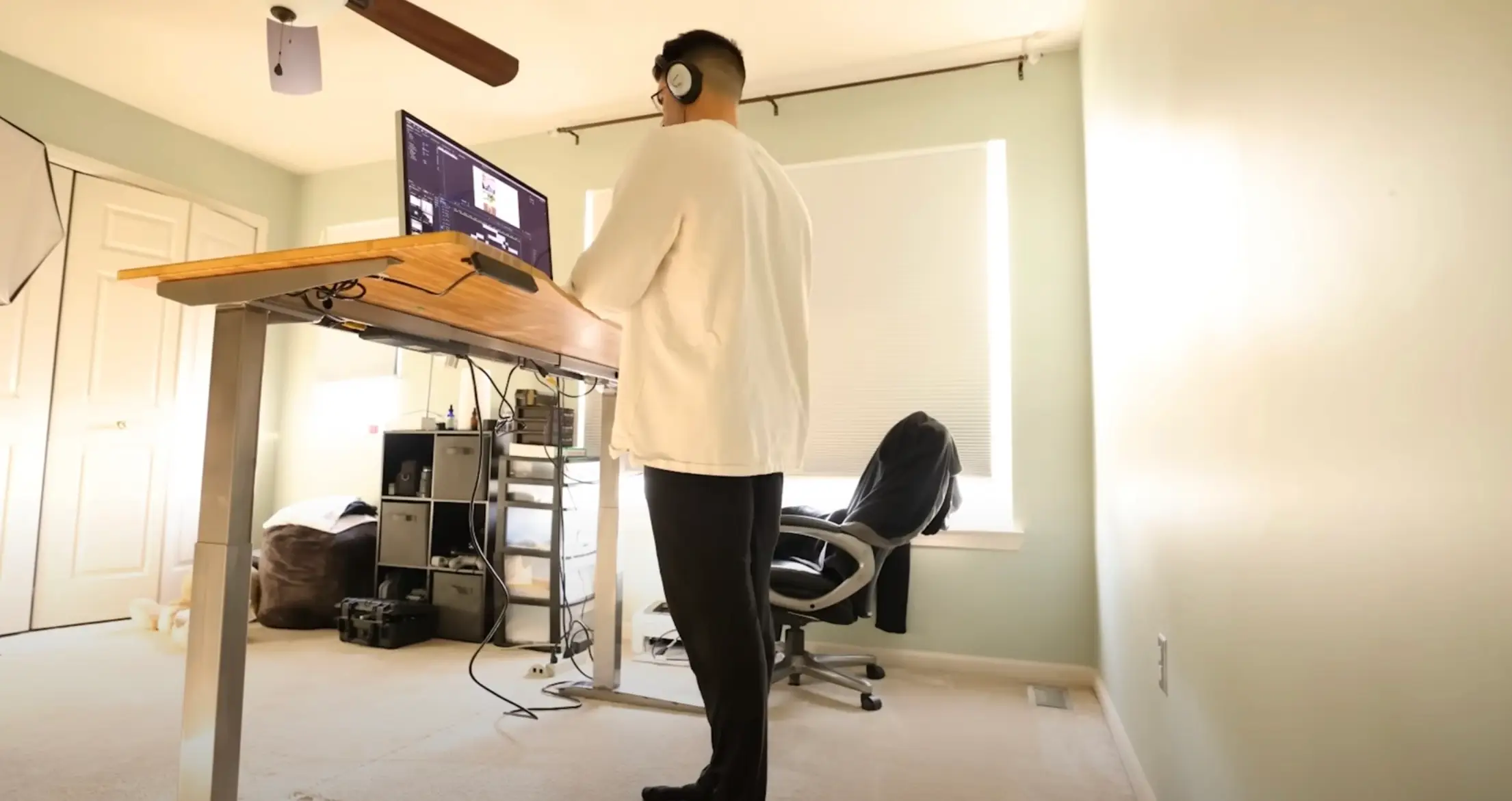 The YouTuber used a standing desk to work, but began to really struggle by day three of the experiment. (YouTube/pigmie)