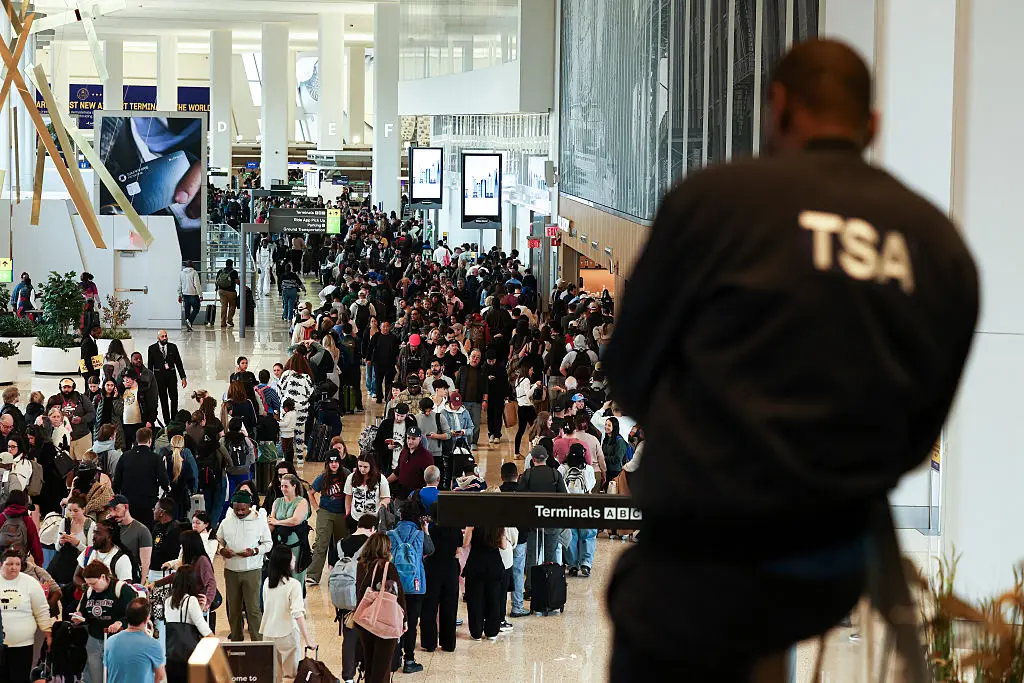 He's checking for security risks, not your stash (CHARLY TRIBALLEAU / AFP via Getty Images)