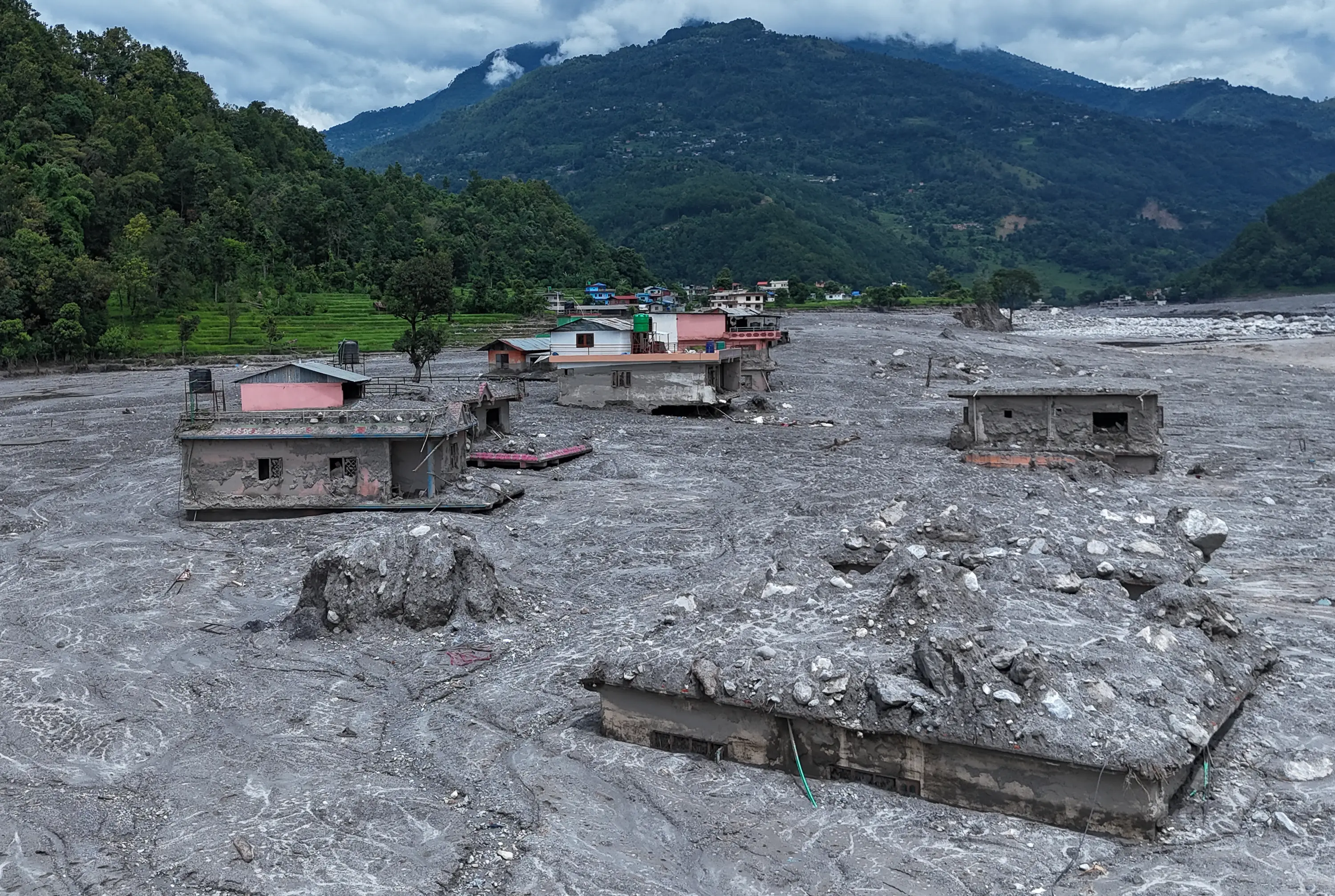 An aerial view of houses surrounded by debris in Rasuwa following the flash floods (Ritesh Shukla/Getty Images)