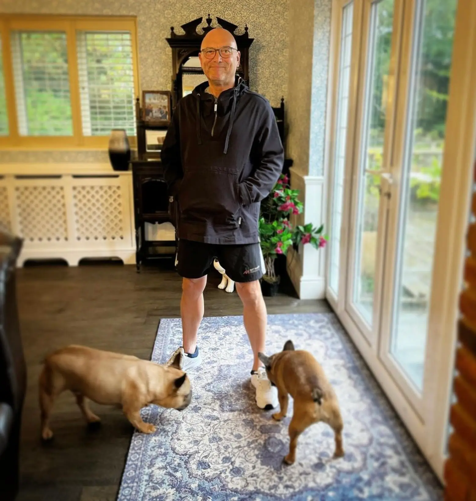 He enjoys playing with his young son and their two dogs.