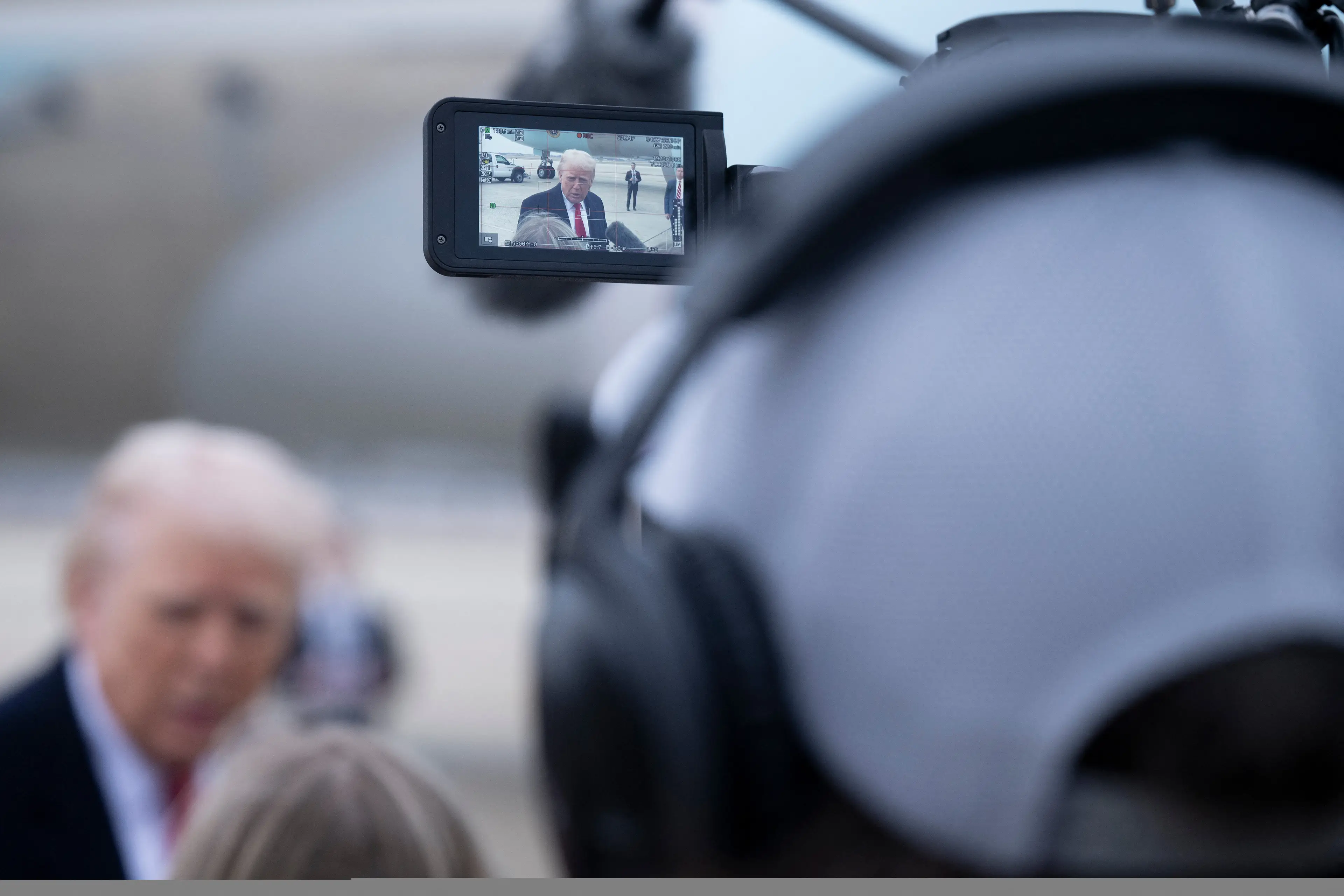 Those fluffy things are boom mics, someone caught Trump in the face with one (BRENDAN SMIALOWSKI/AFP via Getty Images)