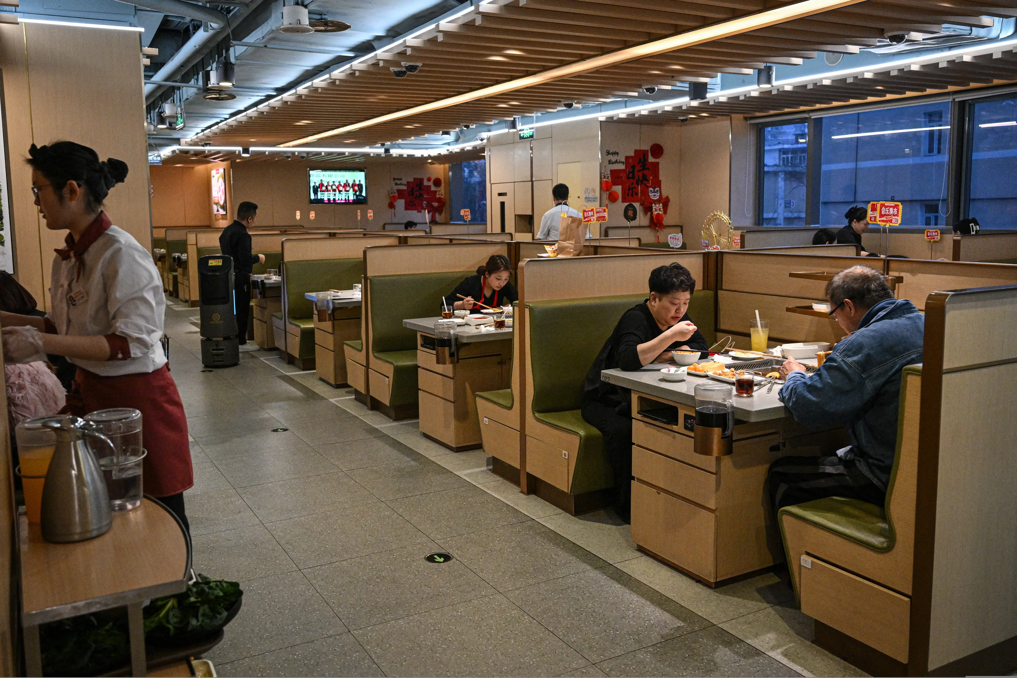 Haidilao diners seen tucking into their hot pot at a Beijing branch (JADE GAO/AFP via Getty Images)