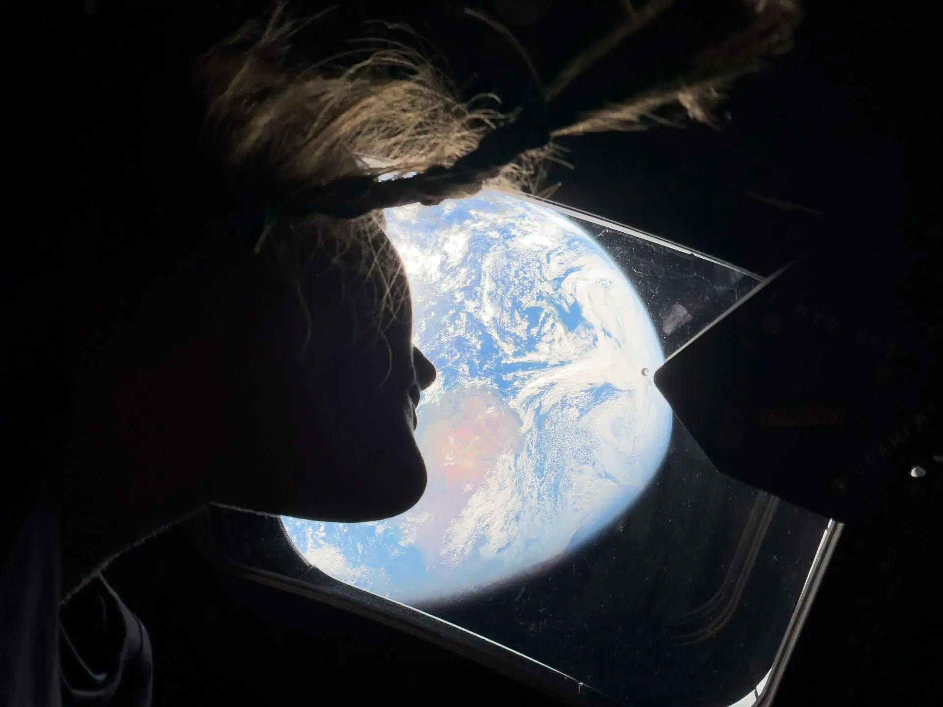 Christina Koch takes a peek at Earth as they journey closer to the Moon (NASA)