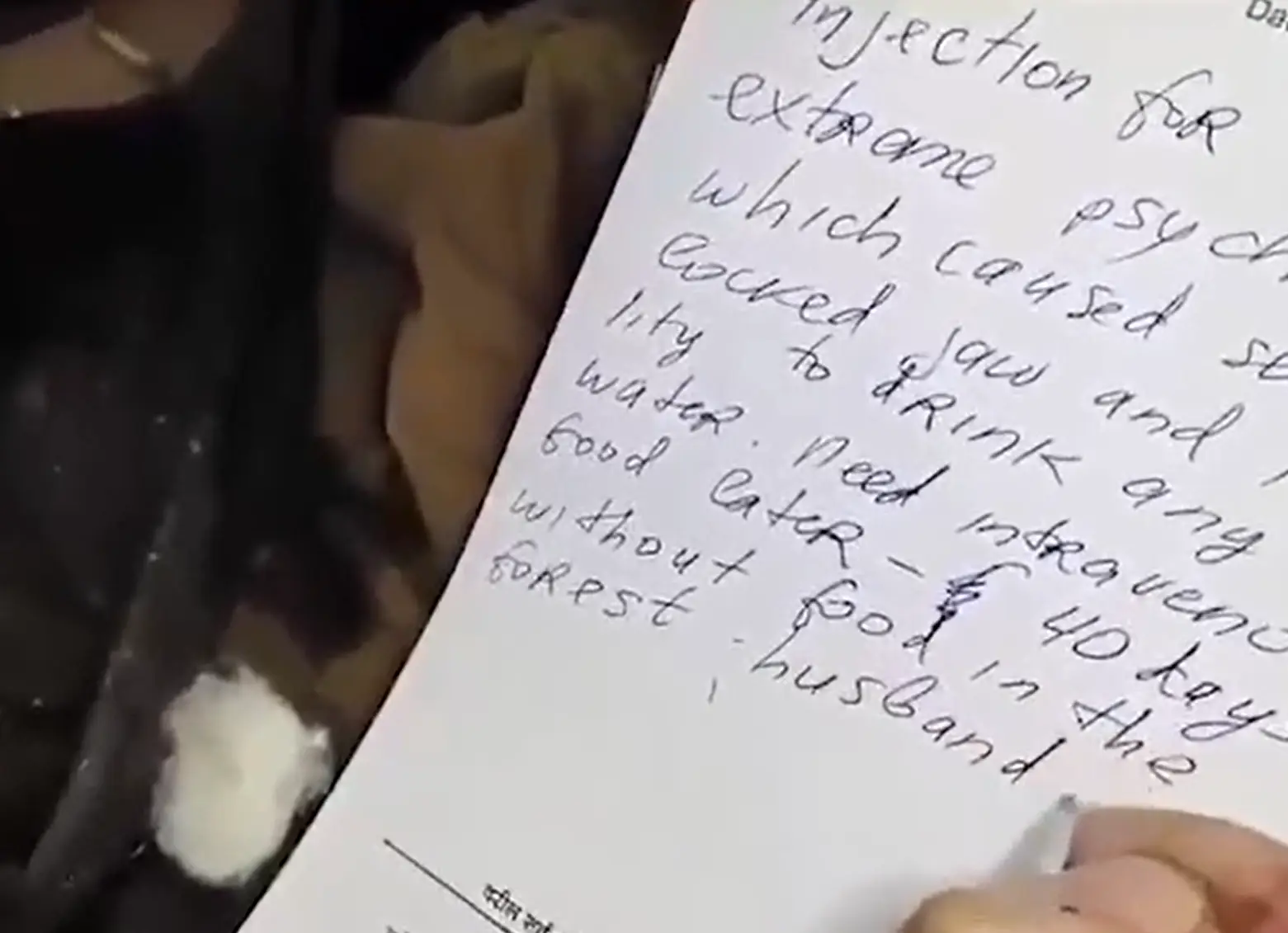 In hospital Lalita Kayi Kumar wrote out a message detailing her ordeal, and claiming her ex-husband was the culprit. (India Today)
