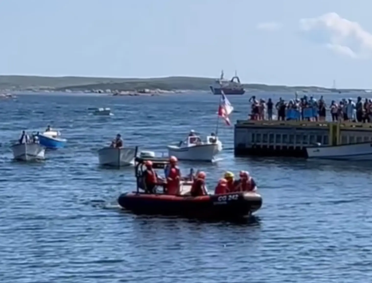 Rescue crews bringing the men ashore. (Facebook/Ryan Hart)