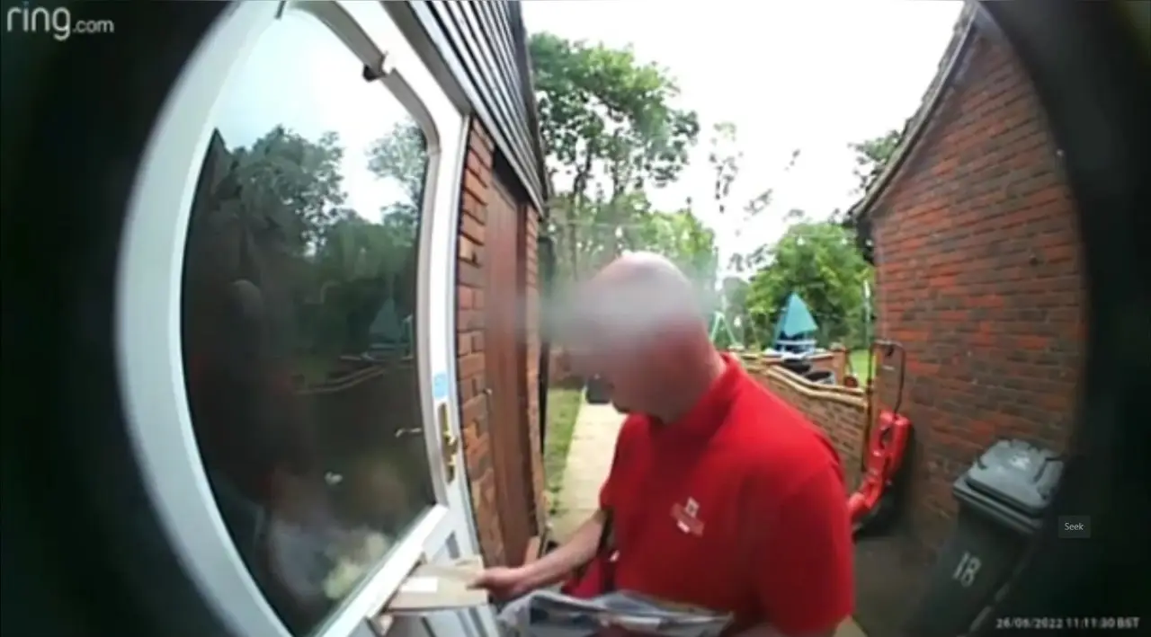 The postman was making a delivery to Lauren's home.