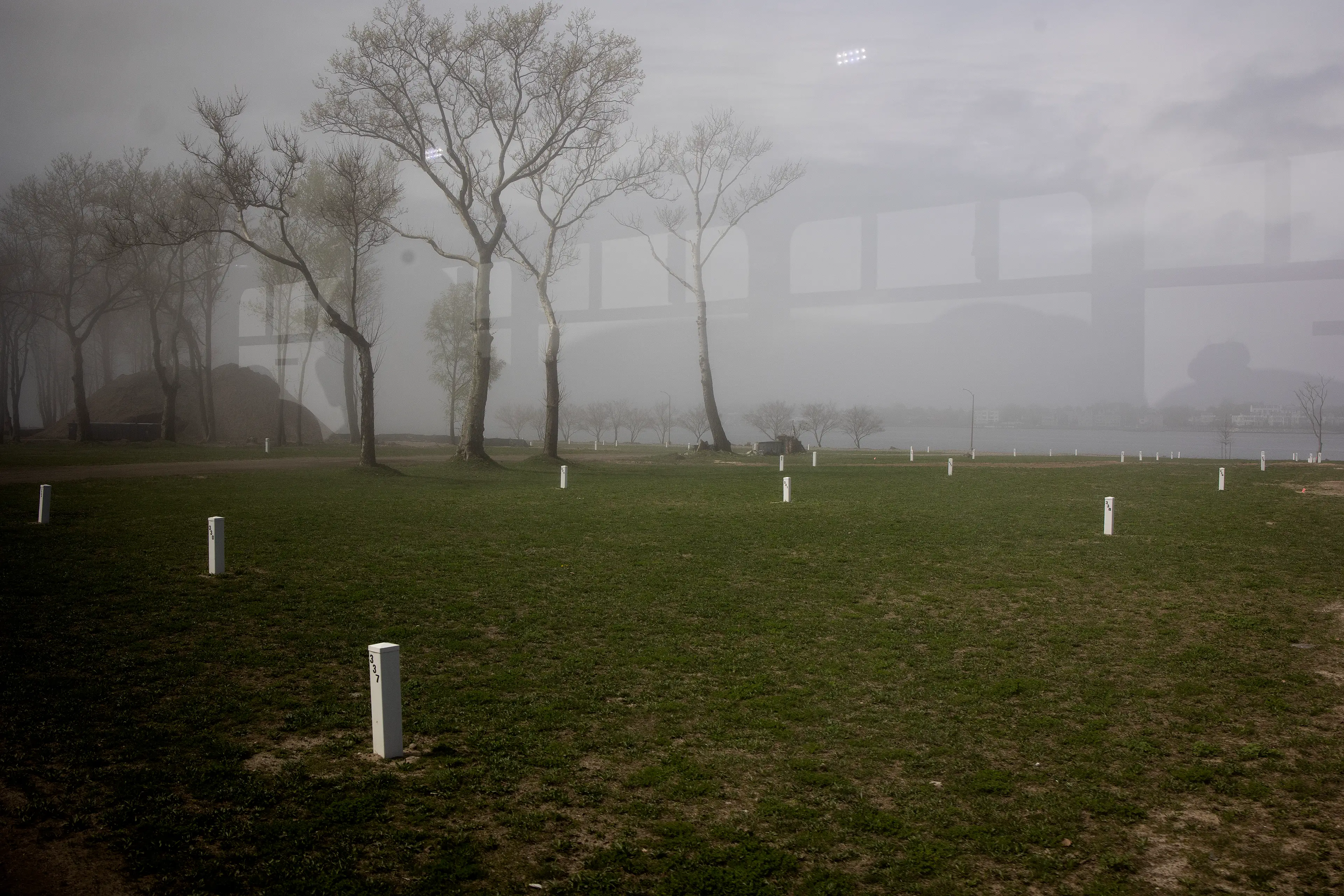 The graves are marked with a white post.