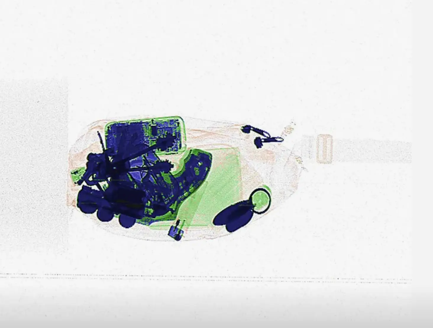 The object is partially visible amongst other items in the bag (Simulscan)